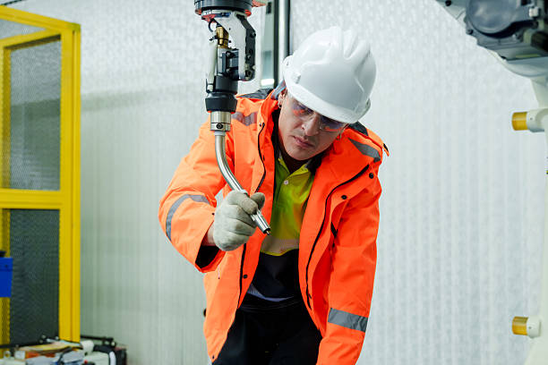 istock male technician inspecting robotic welding tool during hands on training in automated factory environment focused on precision tasks for smart industry workforce development 2228944970