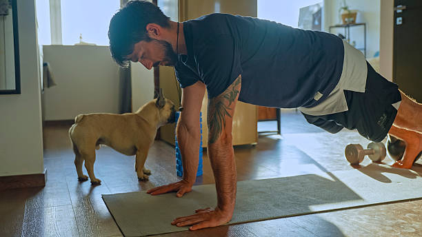 istock Man Doing Push-Ups with his Dog at Home 2228947287
