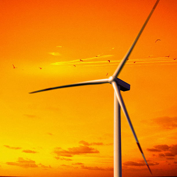 One wind turbines over orange color dramatic sunset sky