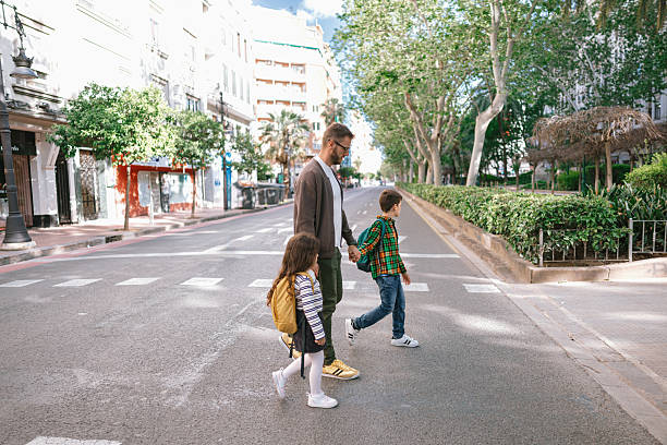 istock Father and Children Using Crosswalk on Their Way to School 2228951011