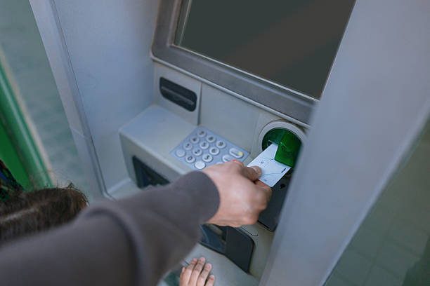 istock Father With Two Children Using ATM to Withdraw Cash 2228951050