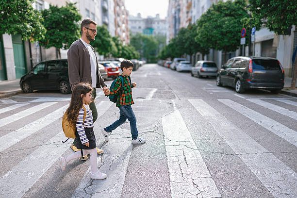 istock Father and Children Using Crosswalk on Their Way to School 2228951062