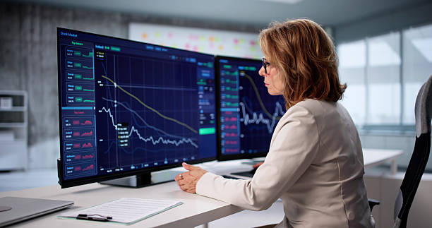 istock Experienced Woman Monitors Stock Data 2228953286