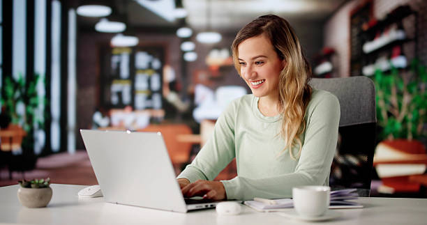 istock Female Business Consultant Smiling, Multitasking With Laptop 2228954049