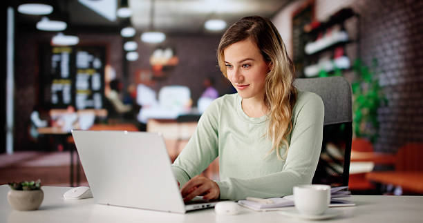 istock Woman Smiling While Working On Laptop 2228954052