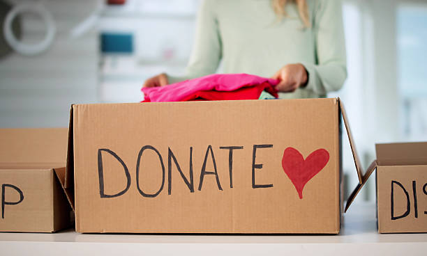 istock Woman Declutters Wardrobe, Sorts Clothes For Donation 2228954067