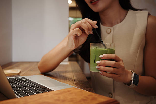 istock Businesswoman savoring a refreshing matcha latte during a work break at a cozy cafe, balancing productivity and relaxation 2228954265