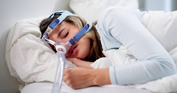 istock Woman Wearing Sleep Apnea Oxygen Mask To Help 2228954431