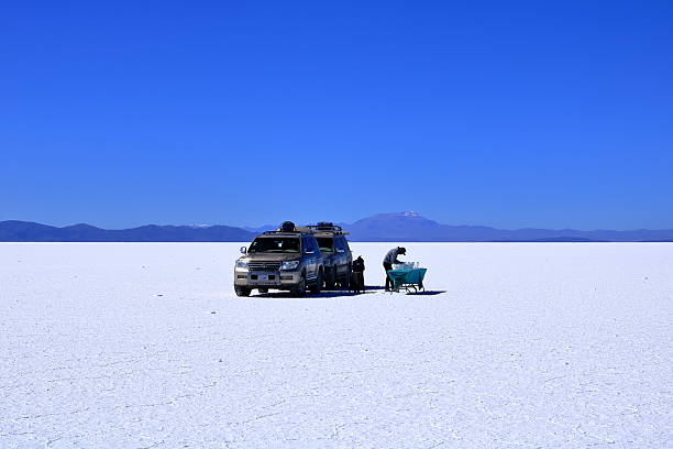 Uyuni in Bolivia - May 27 2025: people explore the salt flat by car