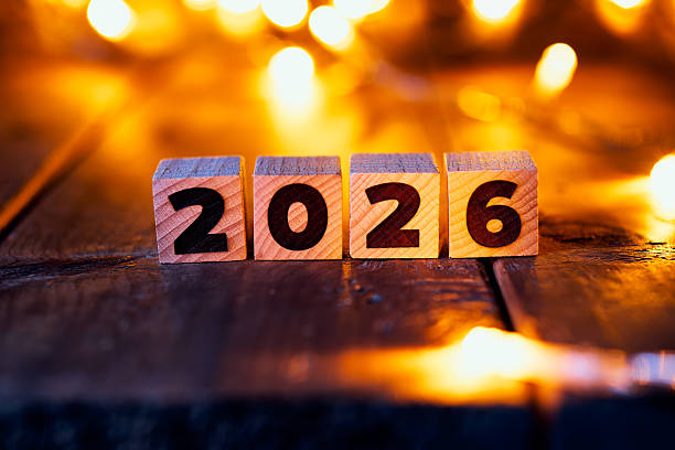 istock Wooden Blocks Displaying 2026 with Glowing Festive Lights in Background 2228957613