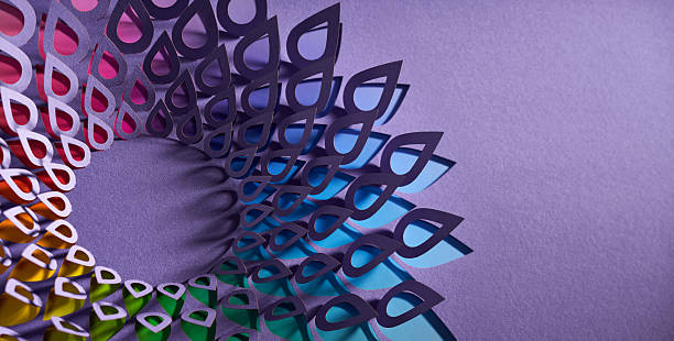 istock Colorful Teardrop-Shaped Paper Mandala in Spiral Pattern on Purple Background 2228957663