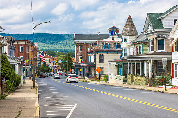 istock Victorian architecture along central avenue in Slatington, PA. Mountain backdrop frames small-town America with historic storefronts and American flags. 2228959304