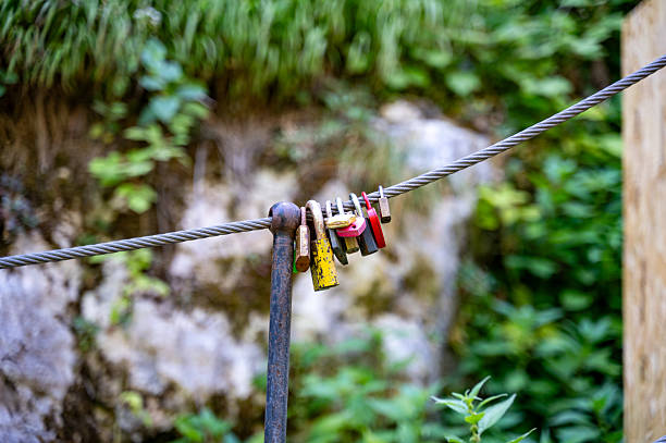 istock Many old and rusty padlocks hanging on a steel cable 2228959761