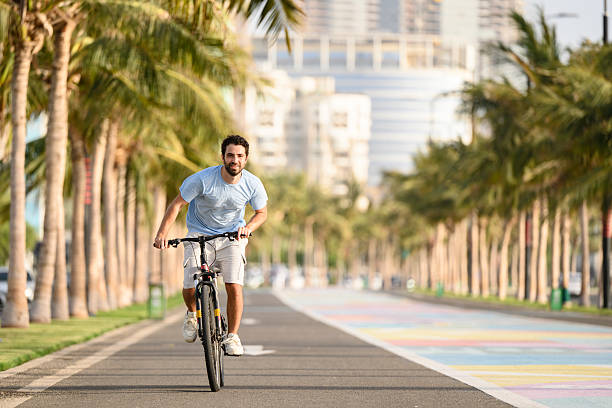 istock Young man riding bike along promenade, Jeddah Corniche 2228961740