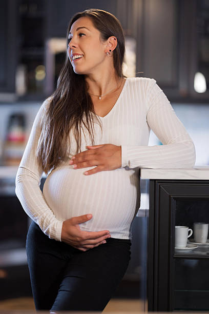 istock Expectant mother enjoying a serene moment in a cozy kitchen setting 2228962481