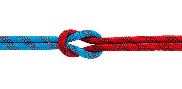 istock Red and blue ropes with reef knot isolated on white background 2228962920