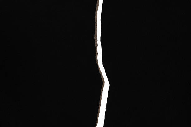 istock Tear out a crack on the black paper 2228963116