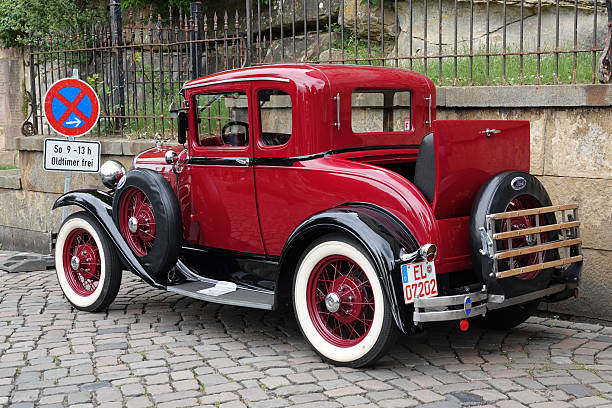 Vintage Elegance: Detailed View of a Classic Car's Chrome Headlight and Iconic Grille - Preserving Automotive History