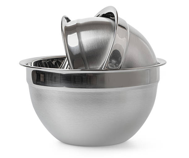 Stainless steel bowl reflecting light on a plain background