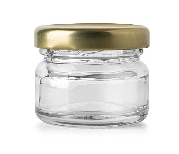 istock Small empty glass jar with golden lid isolated on white background 2228963944
