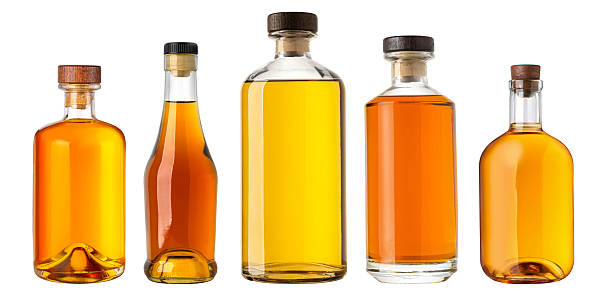 istock Five glass bottles containing amber liquid stand on white background 2228963960