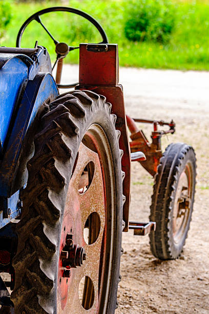 istock Old tractor parked under a clear blue sky in a rural setting, showcasing its weathered beauty and classic design during the sunny afternoon 2228964866