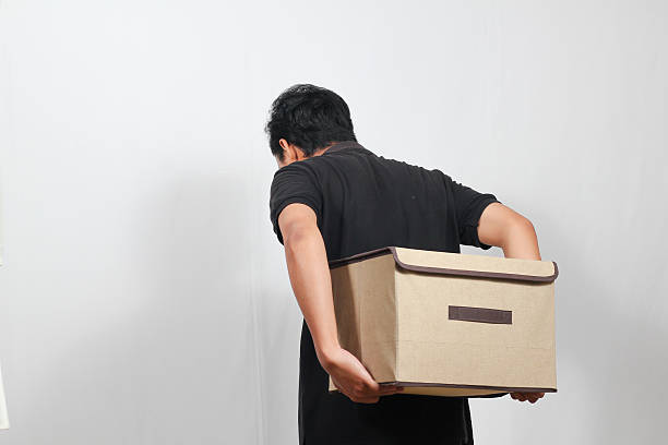 istock Man moving a storage box for decluttering, organizing, or relocating on white background 2228973834