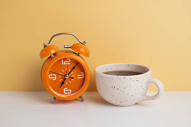 istock Coffee and clock on a colored background.  Time to drink coffee. Break time. Creative idea. 2228974301