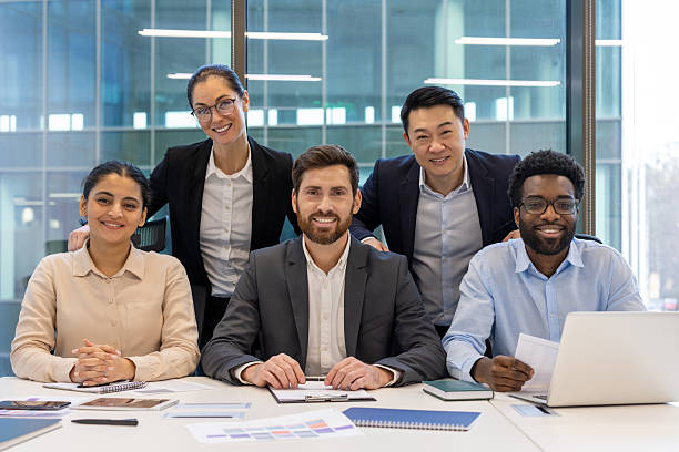 Diverse group of professionals in office setting showcasing teamwork and collaboration in business environment, highlighting positive working relationships and successful team dynamics.