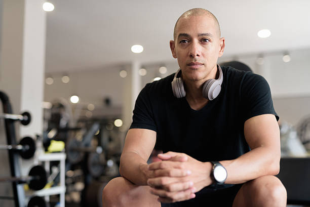 istock Hispanic bald man athlete in gym sitting ready for workout 2228975660