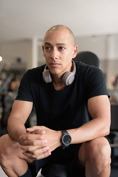 istock Hispanic bald man athlete in gym sitting ready for workout 2228975666
