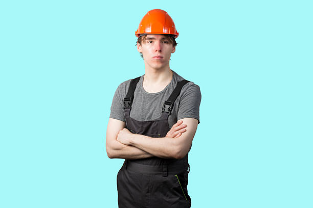 istock A young man wearing an orange construction helmet. Isolate. 2228976403