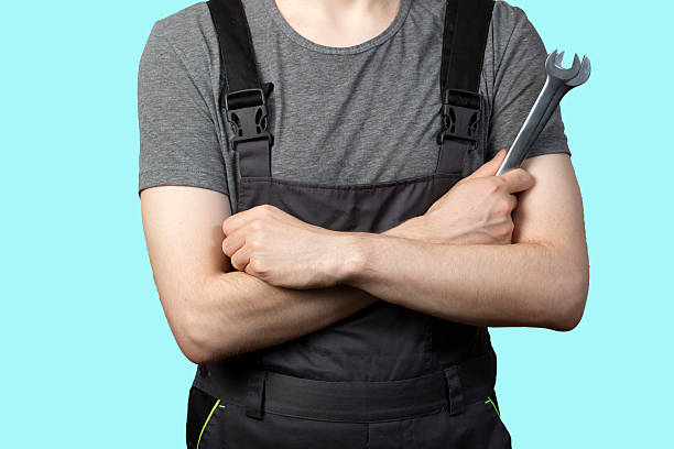 istock A young man, a car service worker with a wrench in his hand. Isolation. 2228976967