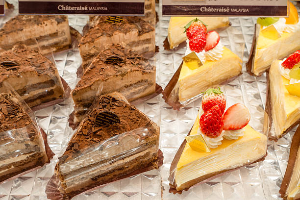 istock Delicious chocolate and fruit cakes displayed on a shiny surface in a bakery showcase 2228977554