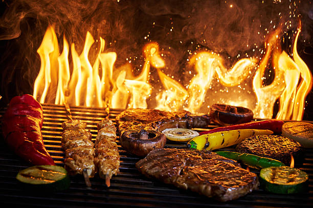 istock Variation of Meat and Vegetables on BBQ Grill with Open Flames 2228979805