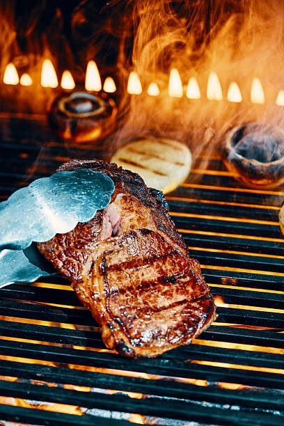 Steak on BBQ Grill with Open Flames