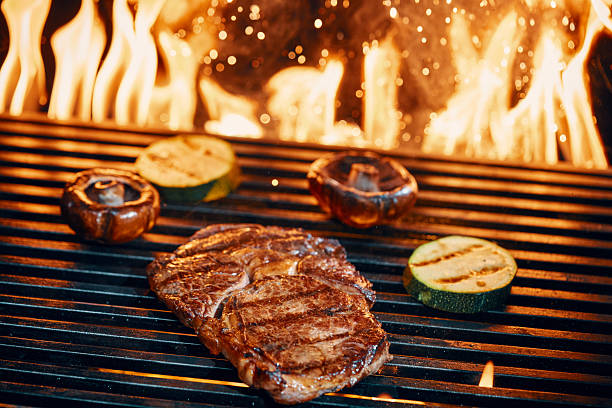 istock Steak on BBQ Grill with Open Flames 2228980000