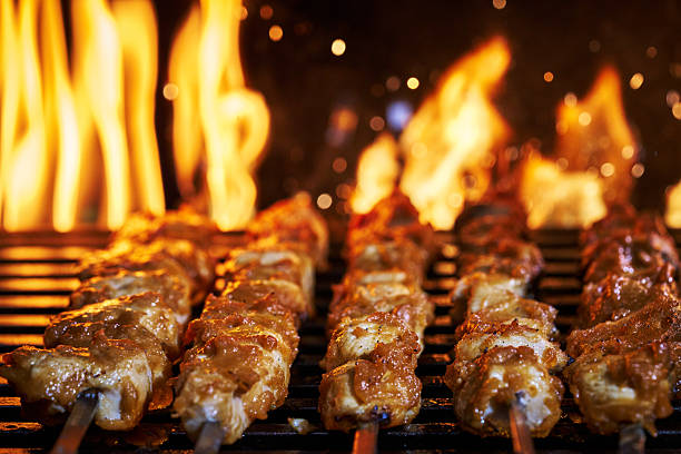 istock Chicken Skewers on BBQ Grill with Open Flames 2228980239