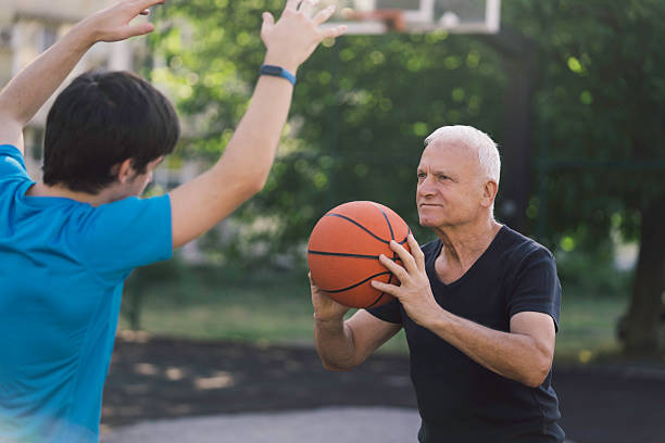 istock Intense Basketball Match Between Generations in Park 2228980311