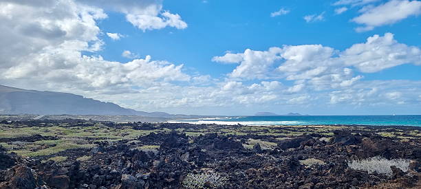 istock Rocky Coastal Landscape with Blue Ocean and Scenic Clouds 2228981511