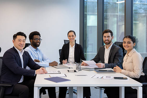 istock Diverse business team in modern office engaged in meeting discussion, showcasing teamwork, professionalism, and collaboration at work with documents and electronic devices on white table. 2228981543