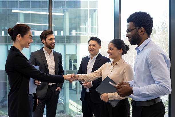 istock Business colleagues shaking hands in a modern office, celebrating a successful agreement. 2228981597