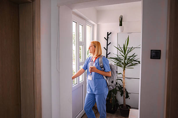 istock Female Doctor Leaving Home After Work, Holding a Refreshing Drink 2228981616