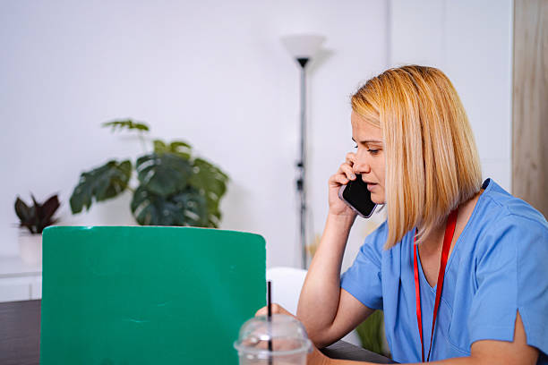 istock Female doctor talking on the phone and taking notes at home 2228981756