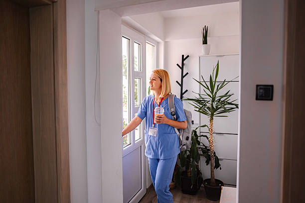 istock Female Doctor Leaving Home for Work, Holding Backpack and Coffee 2228981766