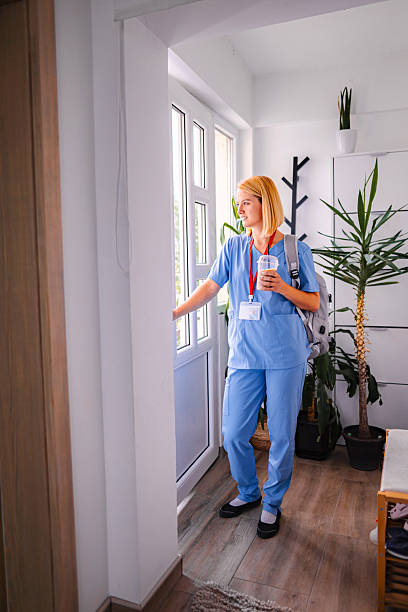istock Female doctor leaving home for work, holding coffee and backpack 2228981783
