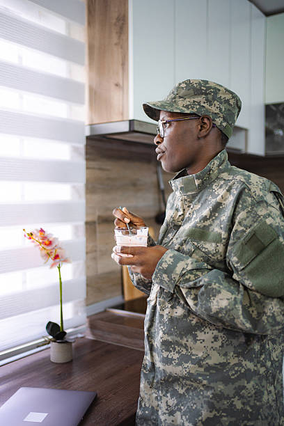 istock Soldier enjoying breakfast while looking out the window in his kitchen 2228981834