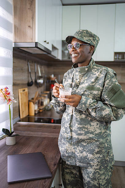 istock Smiling african american soldier enjoying breakfast in kitchen 2228981933