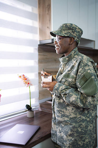 istock Smiling african american soldier enjoying breakfast in kitchen 2228981969
