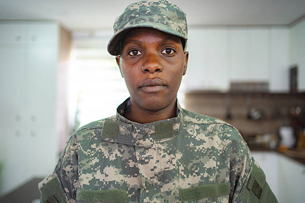Portrait of serious young female soldier in military uniform